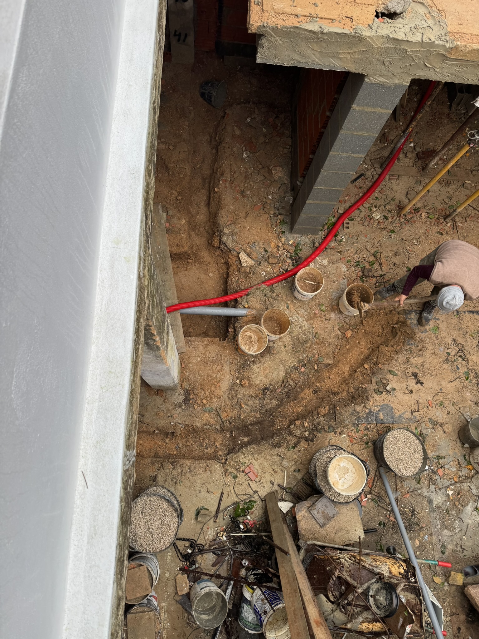 trenches for new plumbing and AC