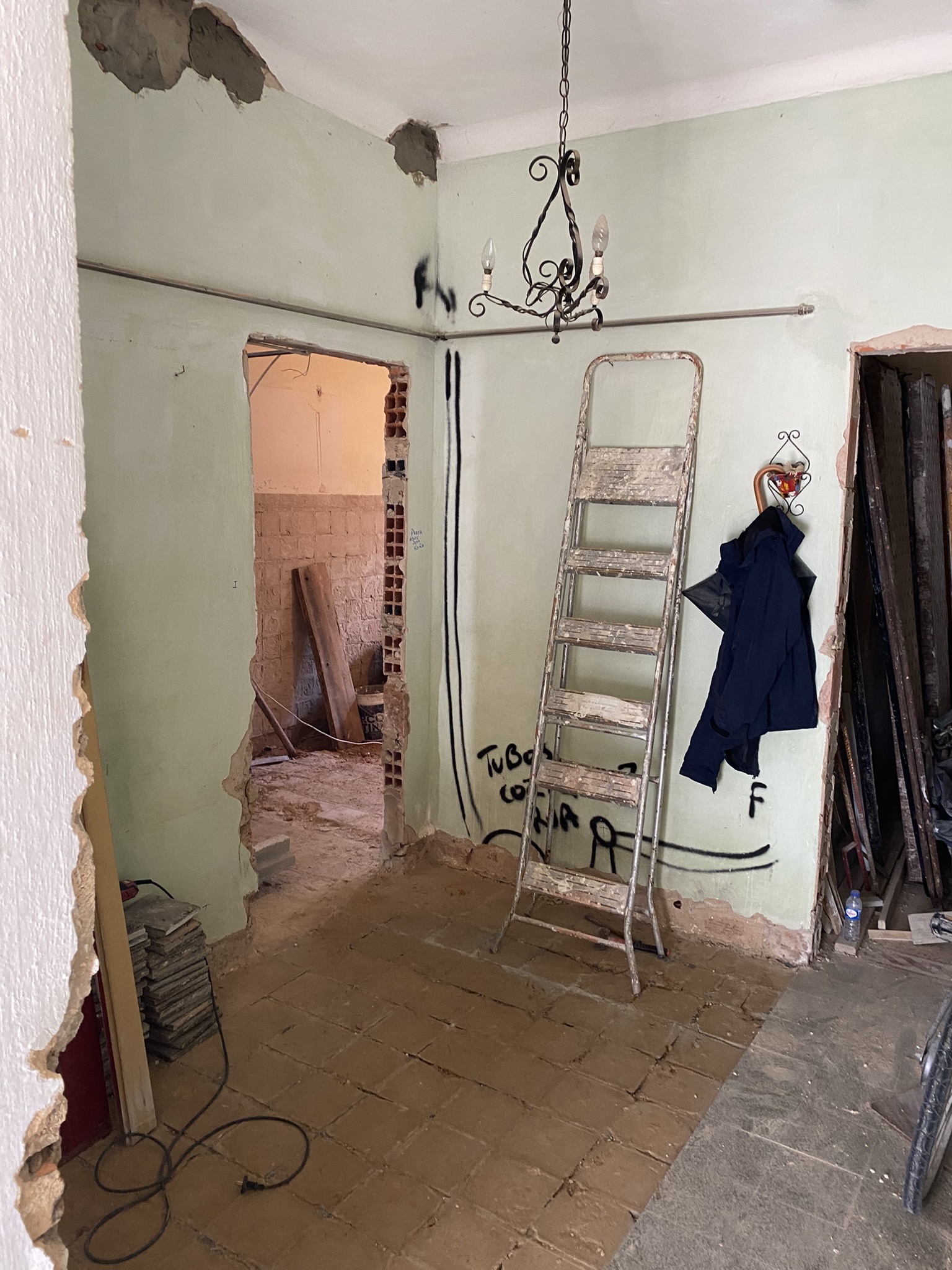 The ground floor apartment entry defined by missing floor tiles