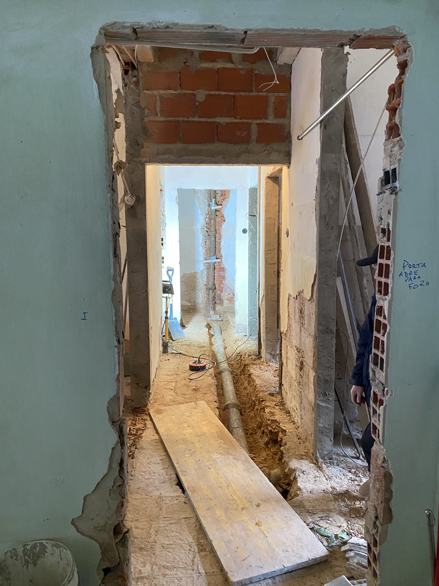 Hallway floor with old sewage pipes
